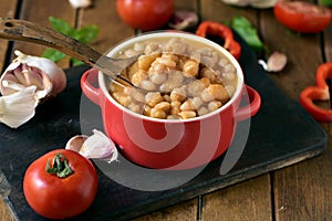 Potaje de garbanzos, a spanish chickpeas stew, on a wooden table photo