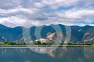 The Potala Palace, the holy place of Tibetan Buddhism by lake photo