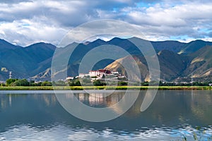 The Potala Palace, the holy place of Tibetan Buddhism by lake photo