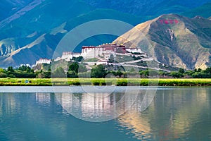 The Potala Palace, the holy place of Tibetan Buddhism by lake photo