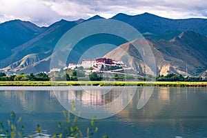 The Potala Palace, the holy place of Tibetan Buddhism by lake photo