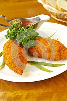 Potato and carrot cutlets with tomato sauce