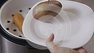 Potato and carrot laid out on a plate close-up