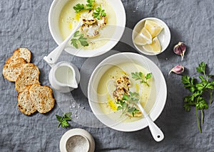 Potato cauliflower soup puree on a gray background, top view. Vegetarian healthy food