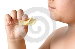 Potato chip in obese fat boy hand