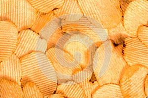 Potato chips background. Fast Food snack texture