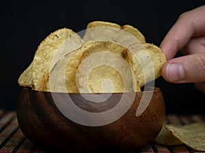 Potato chips in bamboo wooden bowl