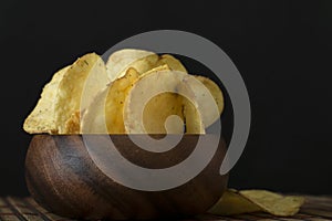 Potato chips in bamboo wooden bowl