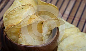 Potato chips in bamboo wooden bowl