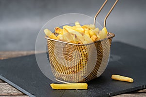 Potato chips in a basket on a board