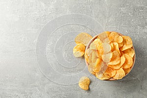Potato chips. Beer snacks on grey background, space for text