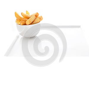 Potato chips in a bowl over white background