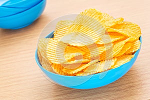 Potato chips in bowl on table