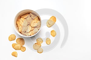 Potato chips and bowl on white background. Junk food concept. Top view. Flat lay