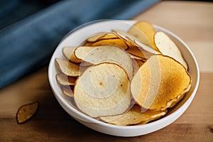 Potato chips in a bowl on a wooden background. easy dip chips, Generative AI