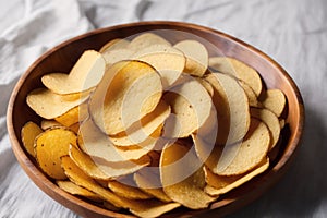 Potato chips in a bowl on a wooden background. easy dip chips, Generative AI