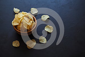 Potato chips on dark blue background.