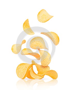 Potato chips fall on a heap with chips isolated on a white