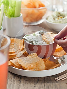 Potato chips and fresh vegetables with dip