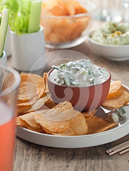 Potato chips and fresh vegetables with dip