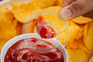 Potato chips and ketchup. Beer snack, unhealthy eating