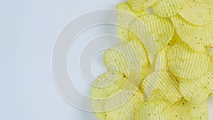 Potato chips macro white background. Unhealthy junk food closeup rotating. Space for text