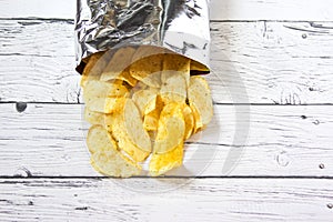 Potato Chips and pack. Packaging of Chip on white background. Potato chips is snack. Top view. Copy space.