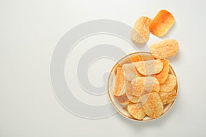 Potato chips in a plate isolated on a white background. Fast food snack