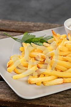 Potato chips on a plate on a wooden board