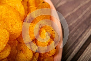 Potato chips on a round platter. Close up