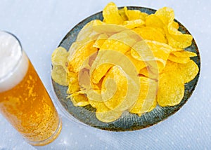 Potato chips served with glass of beer