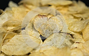 Potato chips in shape of heart close-up photo