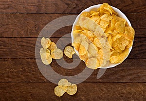 Potato chips on wooden background