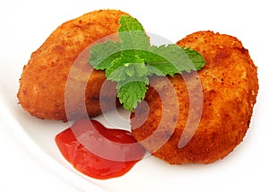 Potato chops with tomato ketchup and fresh mint leaves