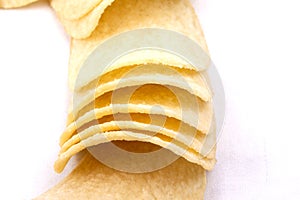 Potato crisps (chips) on a white background