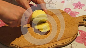 Potato cutting with small knife. Cooking process.