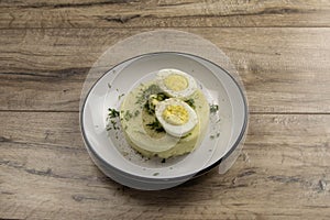 Potato food . Ingredients for mashed potatoes - eggs, milk, butter and potatoes on wooden background