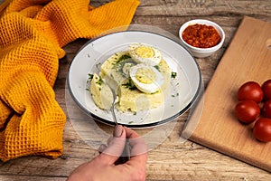 Potato food . Ingredients for mashed potatoes - eggs, milk, butter and potatoes on wooden background