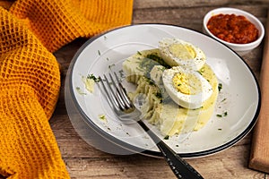 Potato food . Ingredients for mashed potatoes - eggs, milk, butter and potatoes on wooden background