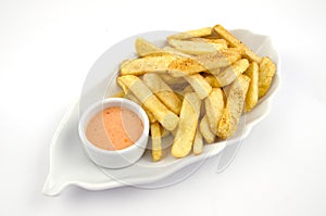 Potato fries and sauce on the plate on the white background