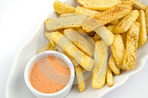 Potato fries and sauce on the plate on the white background