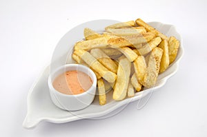 Potato fries and sauce on the plate on the white background