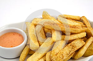 Potato fries and sauce on the plate on the white background