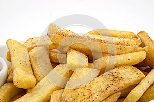 Potato fries and sauce on the plate on the white background