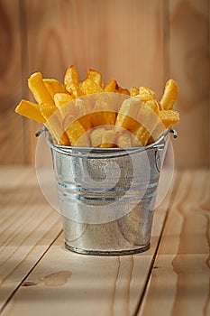 Potato Fries In Stilised Metalic Bucket On Wood Background