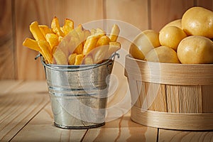 Potato Fries And Whole Potato On Wood Background