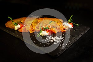 Potato fritter pancake with red caviar, salmon in luxury restaurant