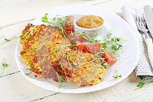 Potato fritters or pancakes served with sauce. European cuisine.