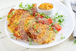 Potato fritters or pancakes served with sauce. European cuisine.