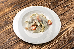 Potato gnocchi with dor blue sauce and cherry tomatoes